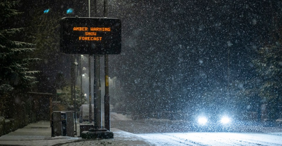 A car pushes through heavy snowfall on the A68 near Inverness, Scotland