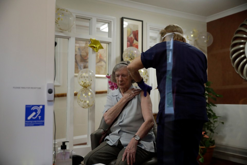 Care home resident Jean Allen, aged 91, receives her first dose of the Oxford/AstraZeneca vaccine at the Wimbledon Beaumont Care Home, January 13