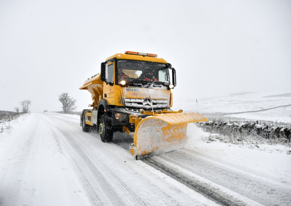 A snowplough clears a snow covered road close to Hadrian's Wall in Northumberland