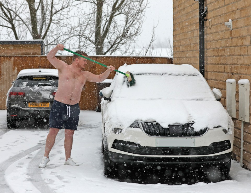 This hardy Brit cleared the snow from his car in Wakefield wearing a pair of shorts