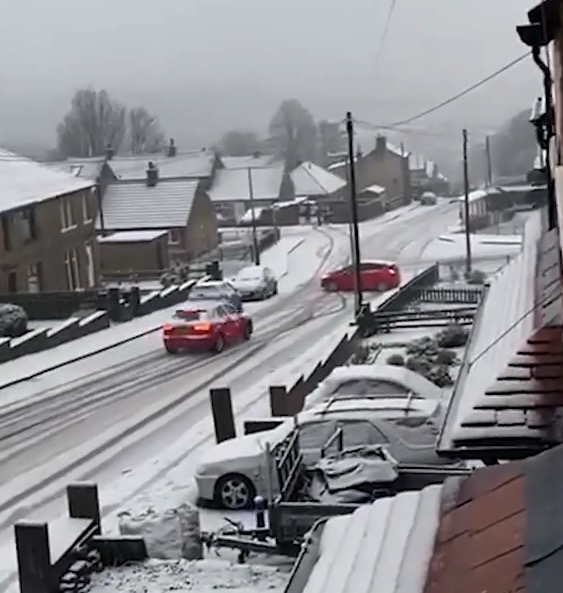 Images show a car careering towards another on a snow-covered road in Huddersfield