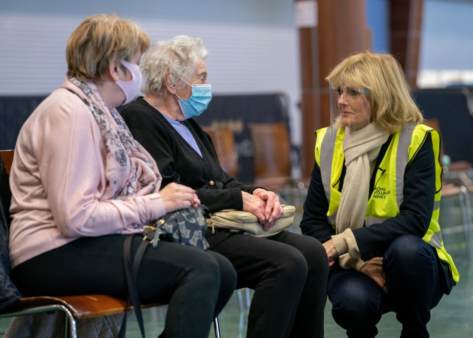 Jane Moore speaking to Betty Smith, 91, and Linda Brooks, 69, from Reigate as they attend a Covid vaccination centre for Betty’s inoculation 