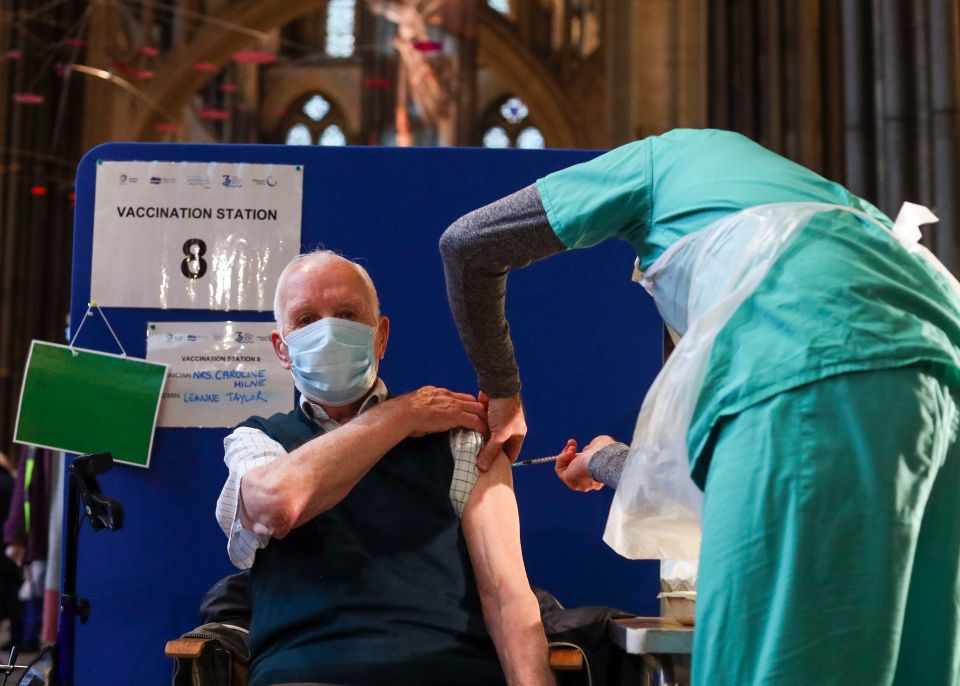 Former RAF Flight Sergeant Louis Godwin receives an injection of the Pfizer coronavirus vaccine at Salisbury Cathedral, Wiltshire