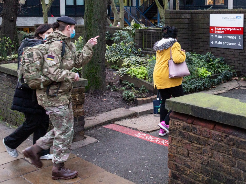 A masked British soldier walks into the Royal Free hospital in North London