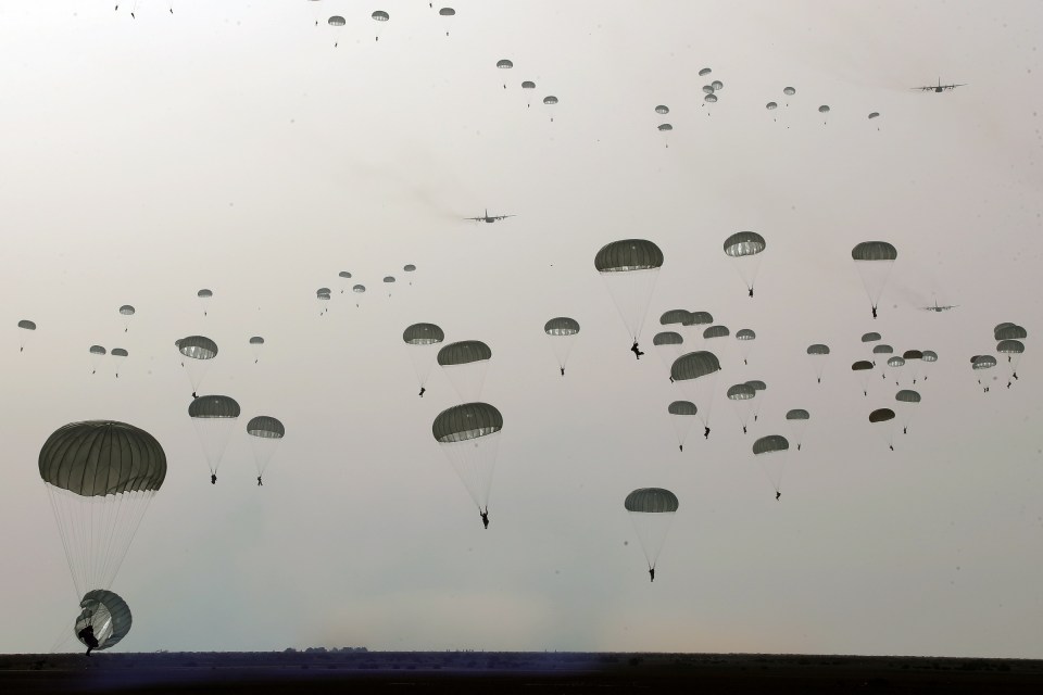 Iranian paratroopers parachuting during a military drill