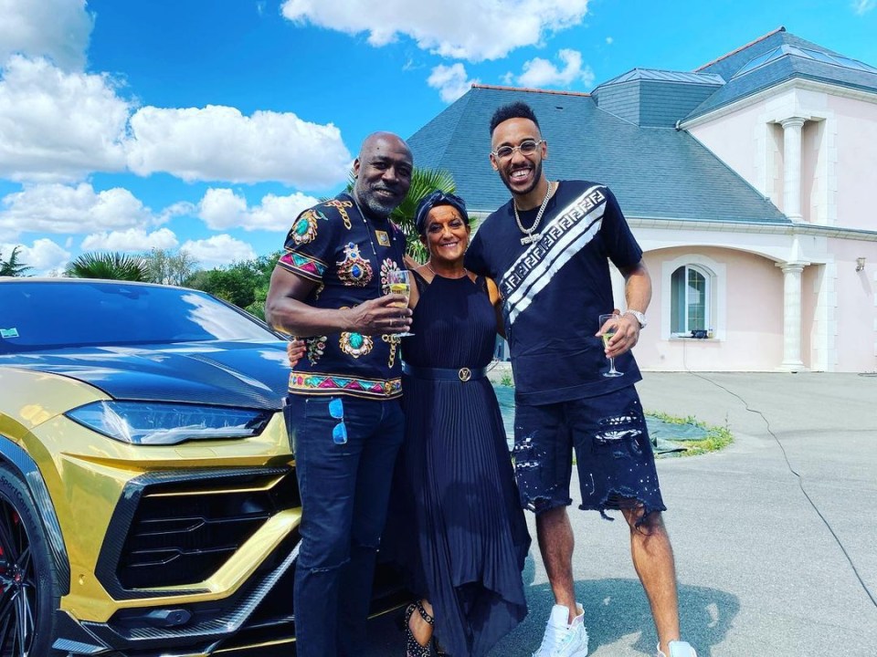 The striker poses alongside his parents