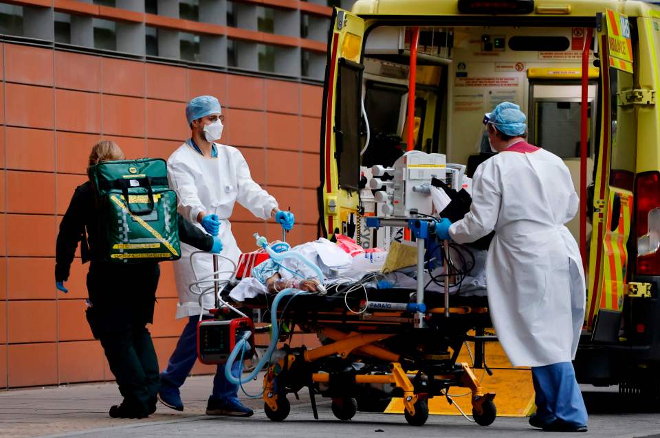 Medics take a patient from an ambulance into the Royal London hospital in London on January 19