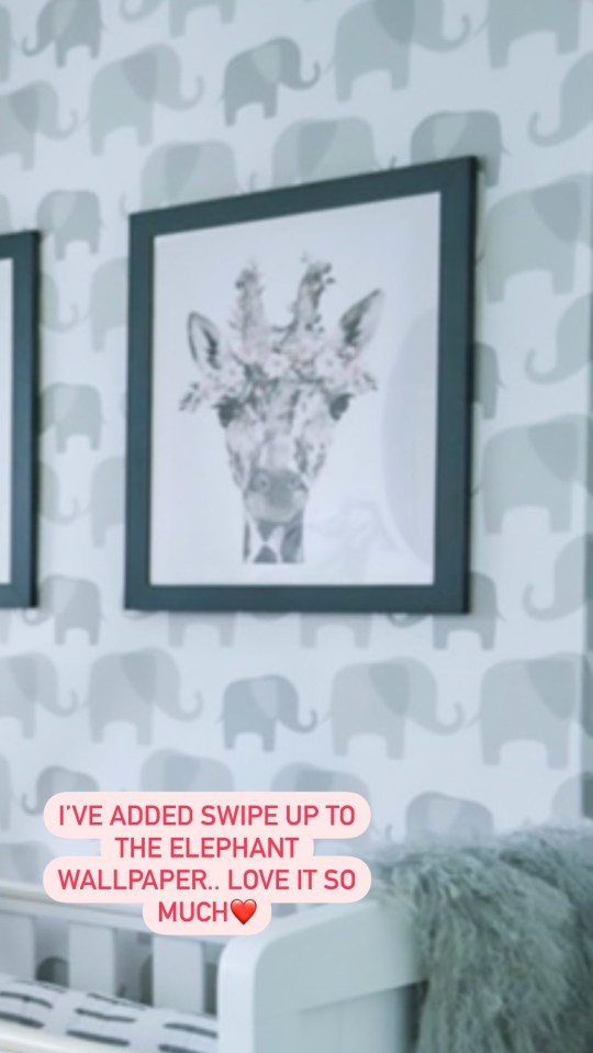 While a cute giraffe print adorns the wall