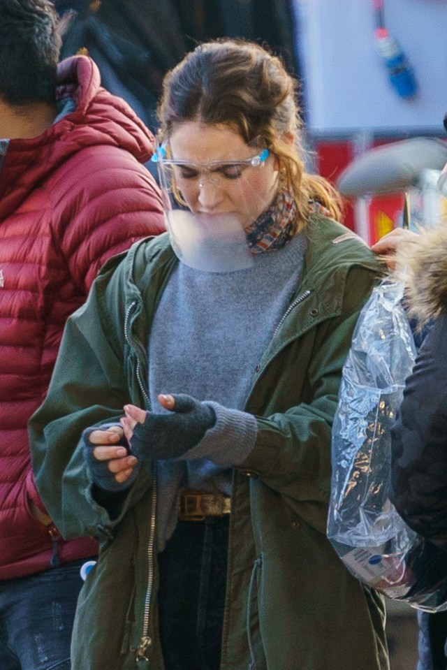 Lily kept warm in a coat, jumper and fingerless gloves