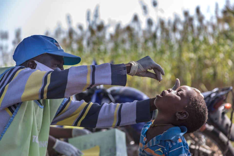 In Shanga, Nigeria, a mobile medical team is seen administering drug to child last year