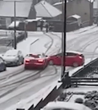 Terrifying footage showed a driver careering into another car in Huddersfield this morning after losing control down a hill