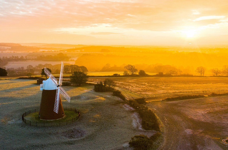 Halnaker Windmill against a golden sunrise this morning in Halnaker, West Sussex