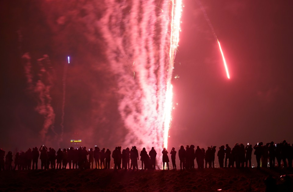 People gather on Everton Brow overlooking Liverpool to welcome 2021