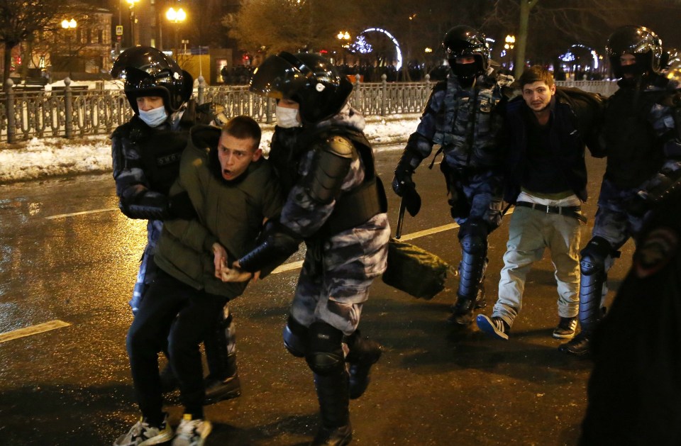 A demonstrator being led away by police in Moscow 