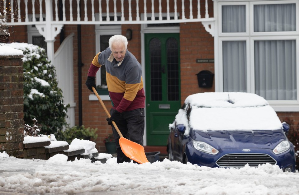 A man shovelling snow in Kent