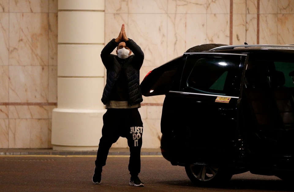 A traveller leaves the Radisson Blu hotel after completing the quarantine period at Heathrow Airport