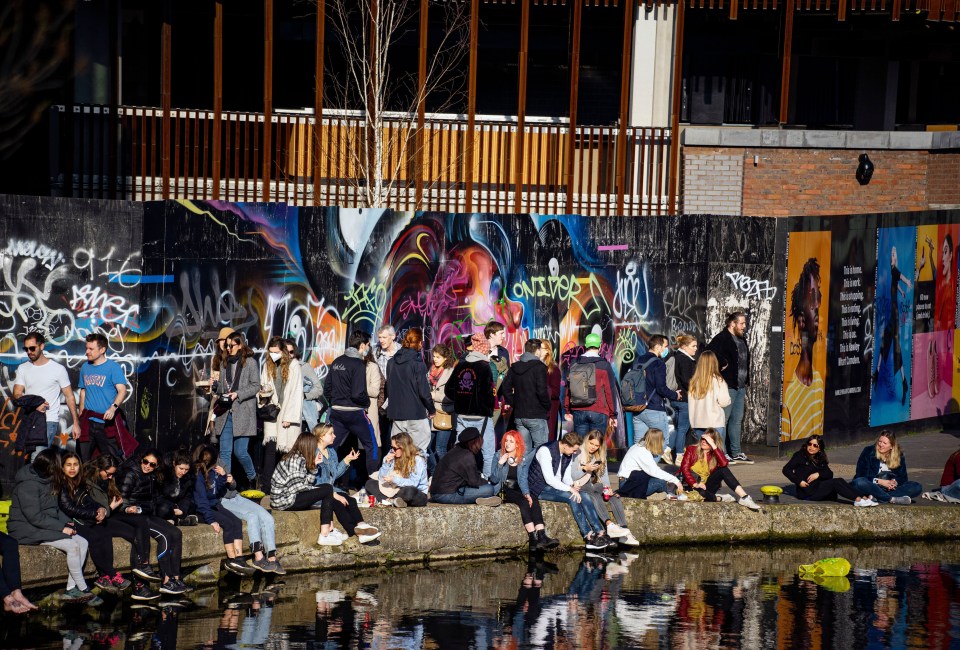 Groups of friends gathered along Camden Lock, London, this morning