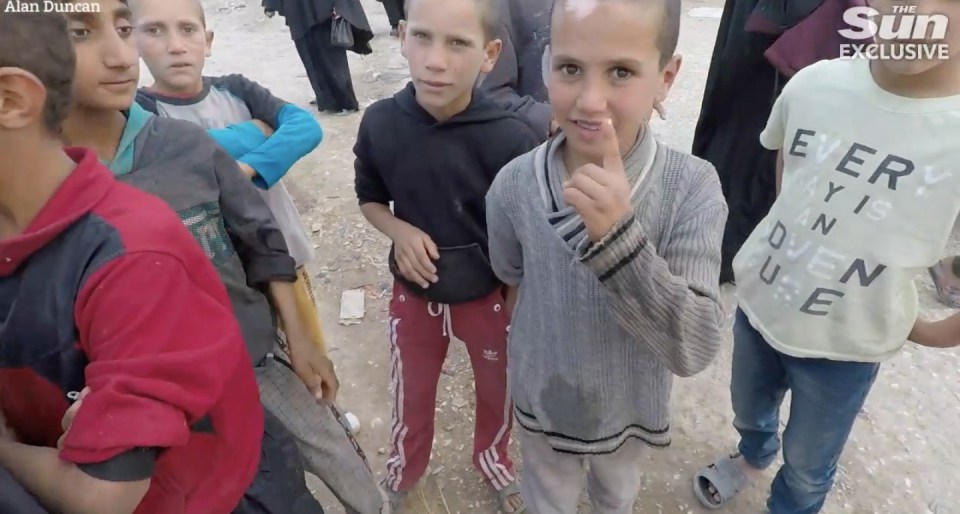 Another child holds up the single finger salute