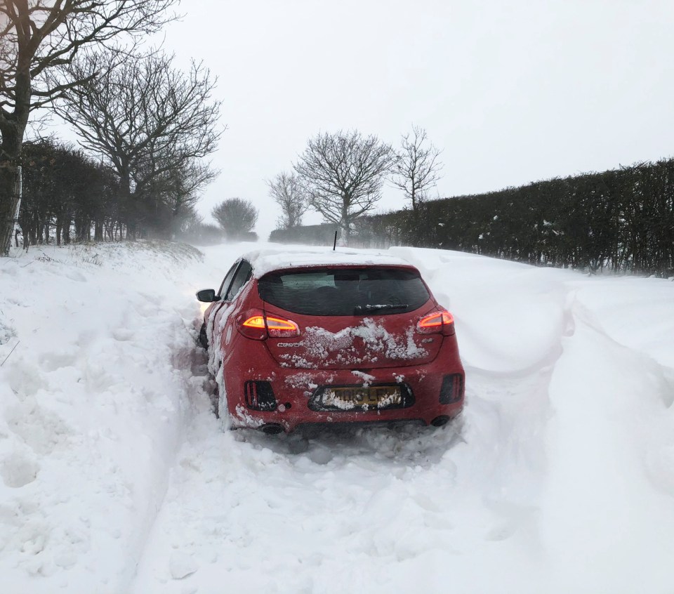 A car stuck in snow in Southrepps, Norfolk