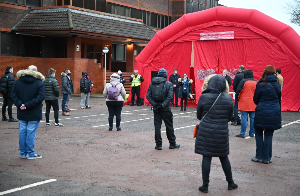 Volunteers are briefed at Woking fire station as local authorities prepare to deploy Covid-19 testing kits