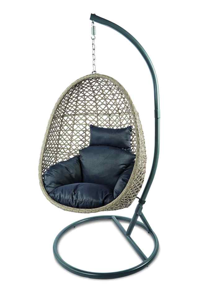 The chair has a grey rattan shell and plush cushions