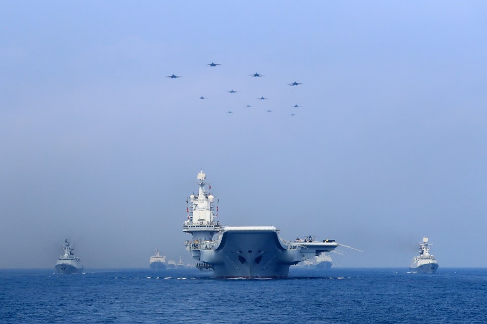 A Chinese aircraft carrier group and fighter jets put on a show of force in the South China Sea in 2018