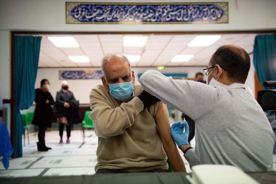 Masud Ahmad, 79, receives an injection of the Oxford/AstraZeneca coronavirus vaccine at the Al Abbas Mosque, Birmingham