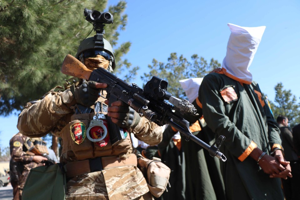 Afghan soldiers parade captured Taliban fighters after an operation in Herat