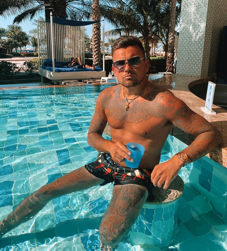 Sam Gowland posing in the pool in Dubai