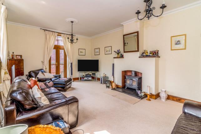 The living room features a log burner to keep the cold at bay