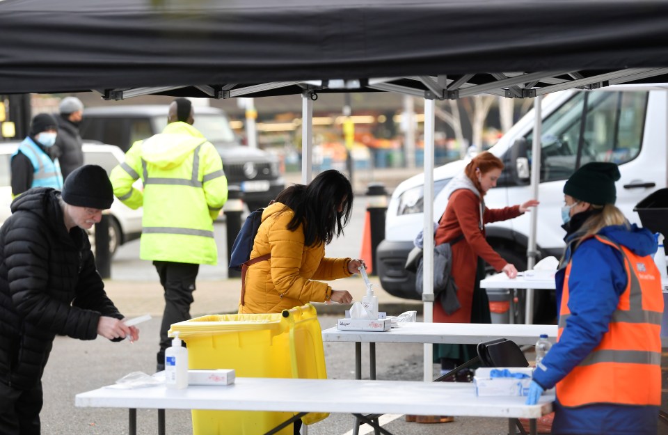 People attend a mobile testing site in Ealing, West London