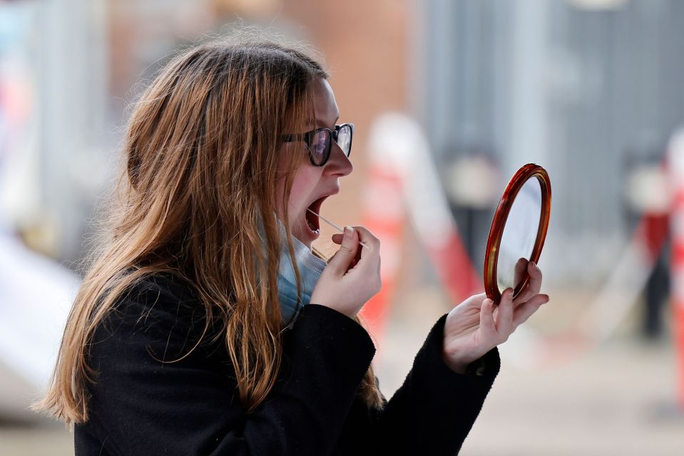 A woman takes a Covid swab test in Ealing, West London, where cases of the South African variant were detected