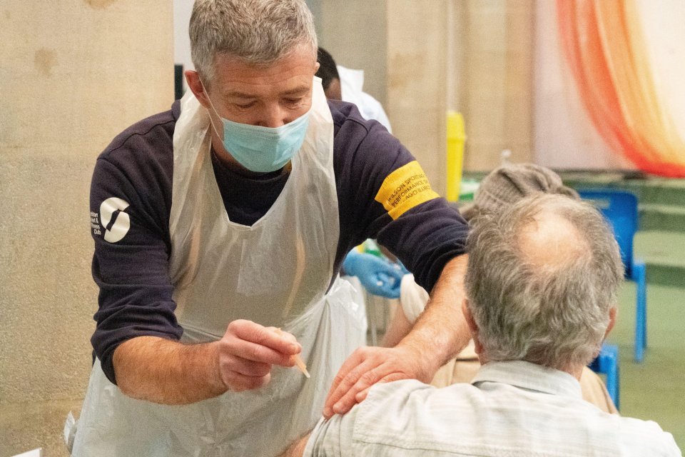 A man receives a Covid-19 jab in a vaccination centre in St John's Church in Ealing, London