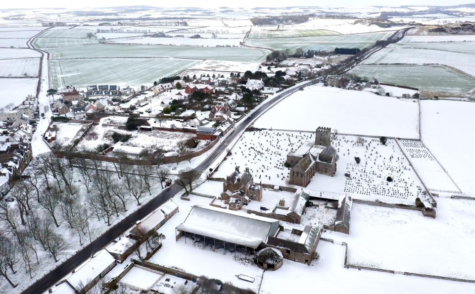 Snowy fields around St Aidan's Church, Bamburgh in Northumberland