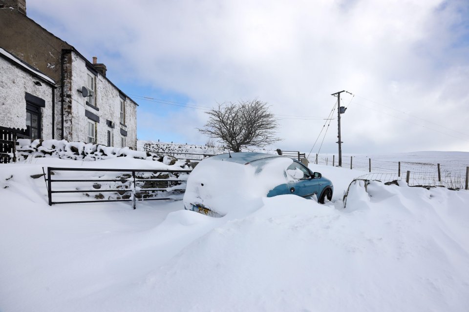 A car snowed in in Harwood, County Durham, as Brits are urged not to travel