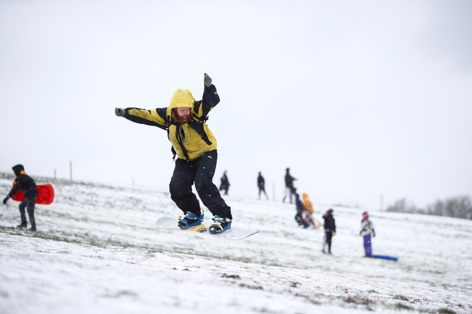 Seb Shower snowboards down Parliament Hill in Hampstead Heath, London