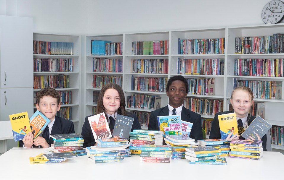 Children from Bristnall Hall Academy in Oldbury, West Midlands, pose with books they were gifted via The Sun's Books for Kids campaign