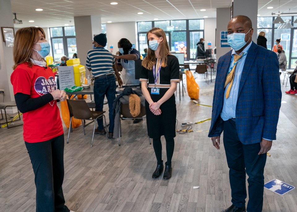 Kay Burley, volunteering at the Tithe Farm Social club vaccination centre in Harrow, chats to doctors