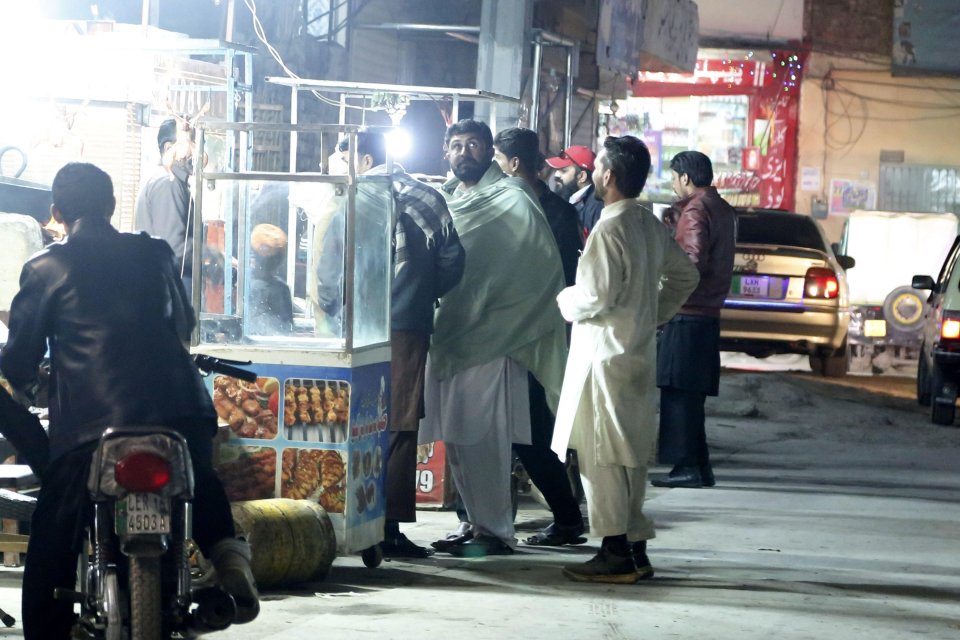 People stand on the street after the earthquake in Rawalpindi, in Pakistan's Punjab province