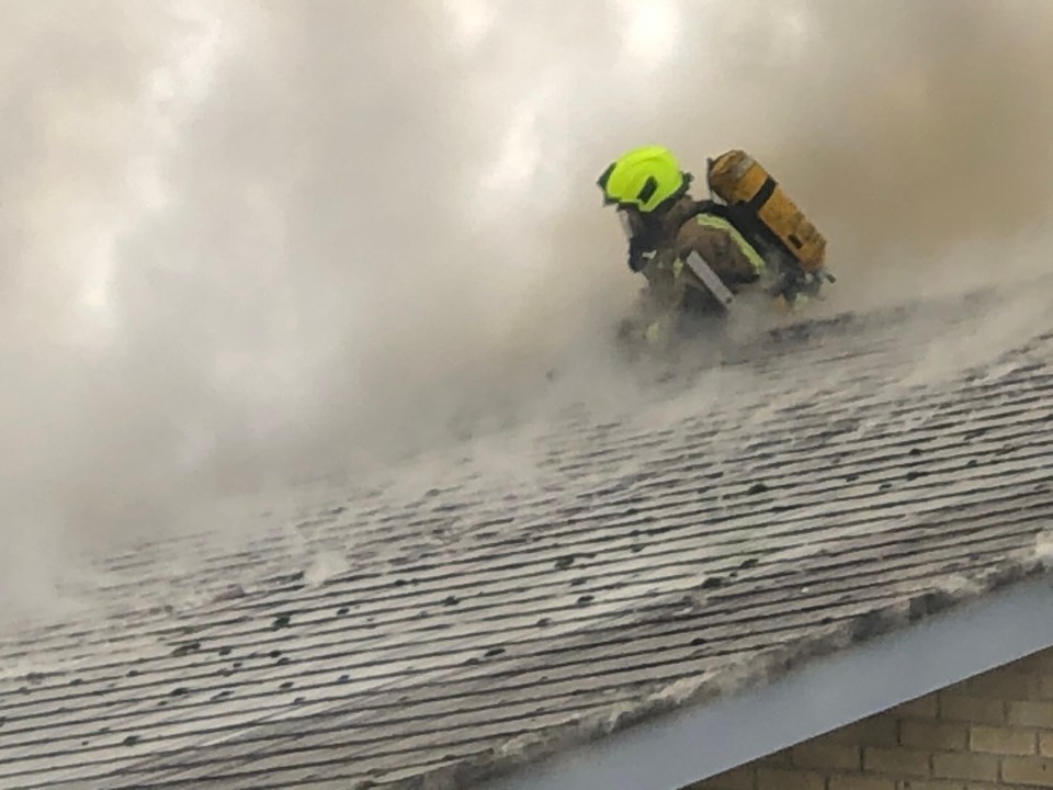 A firefighter can be seen among the flames