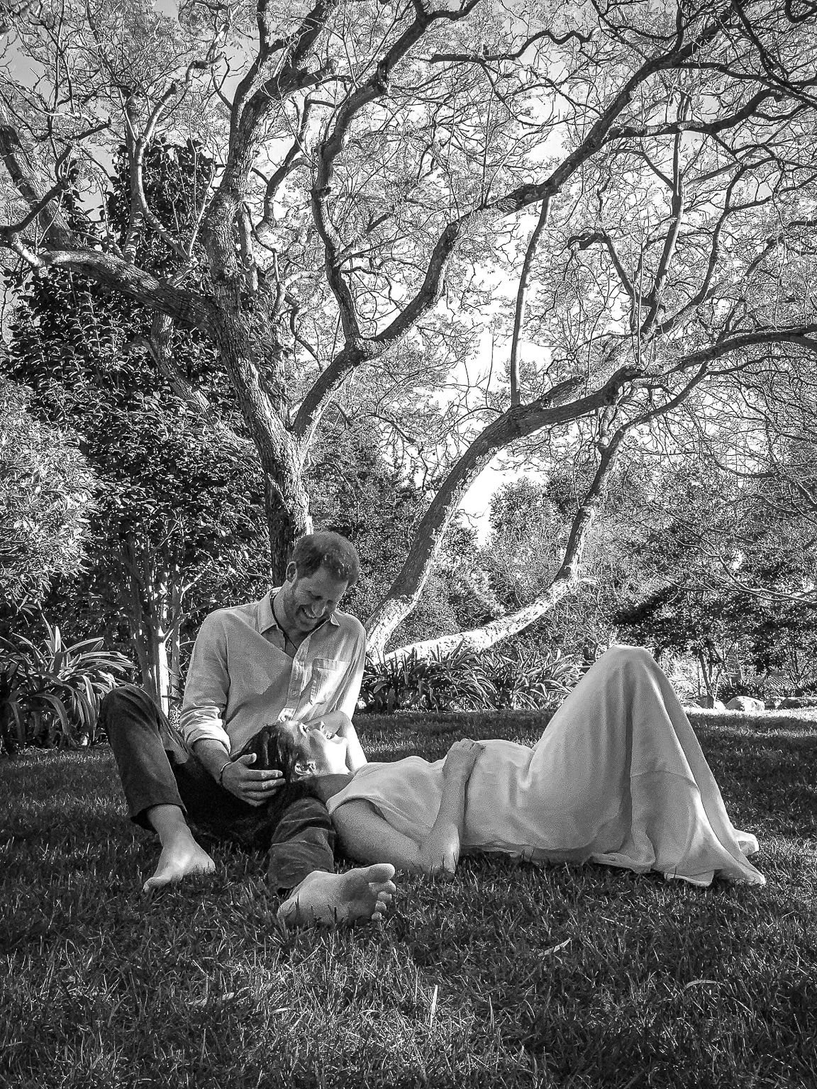 The couple shared a black and white picture of themselves under a tree as they announced they were expecting