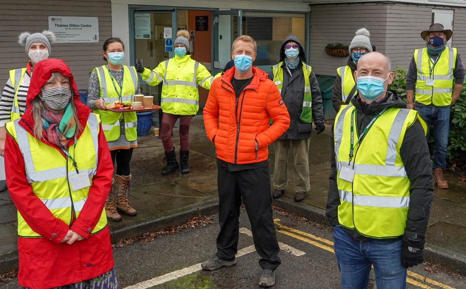 Dr Richard Strickland, pictured with volunteers helping with the roll out of the Covid vaccination, helped wheel the jabs out of a burning building over the weekend