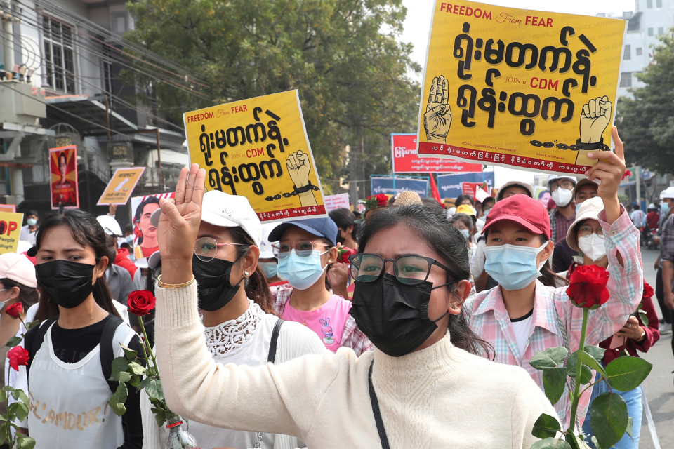 Anti-coup protesters in Myanmar's two largest cities on Saturday paid tribute to the young woman who died a day earlier after being shot by police during a rally against the military takeover