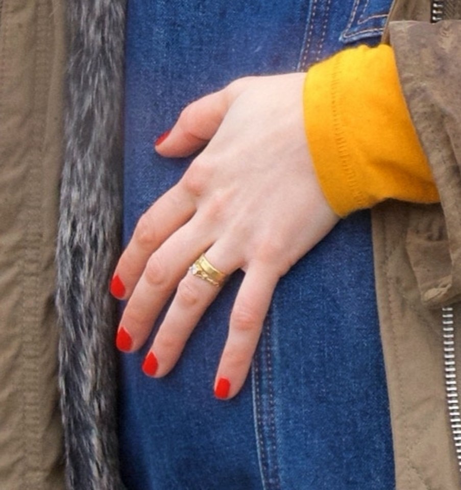 She wore a simple gold wedding band underneath her engagement ring