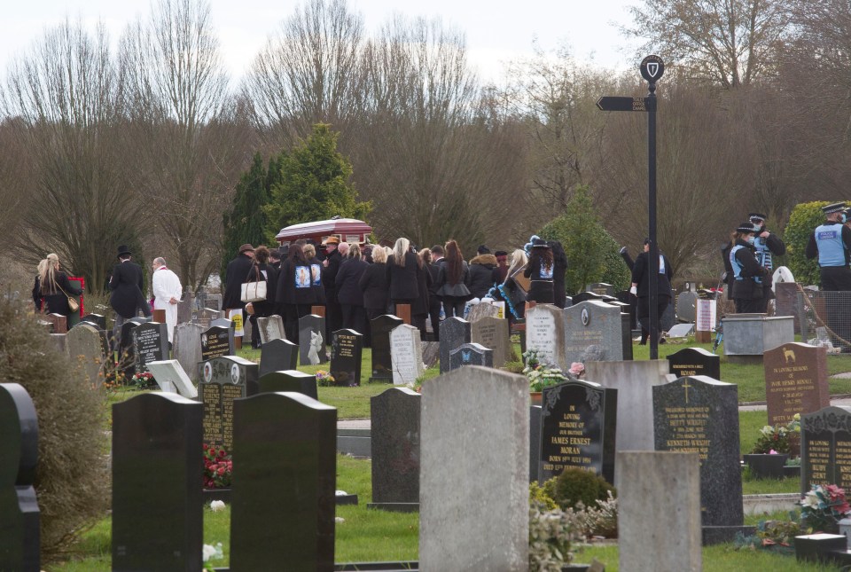 Mourners at the graveyard earlier today