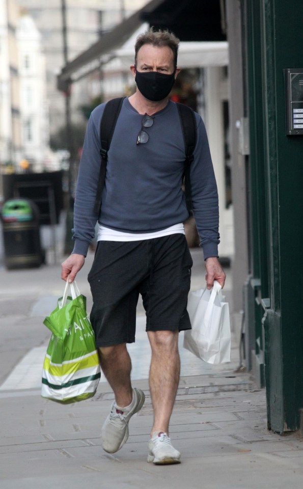 Jason Donovan looks on top form once more, carrying two bags of shopping as well as a rucksack