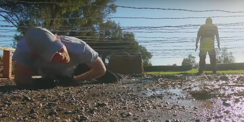 Harry crawls in the mud during the pair's visit to an obstacle course