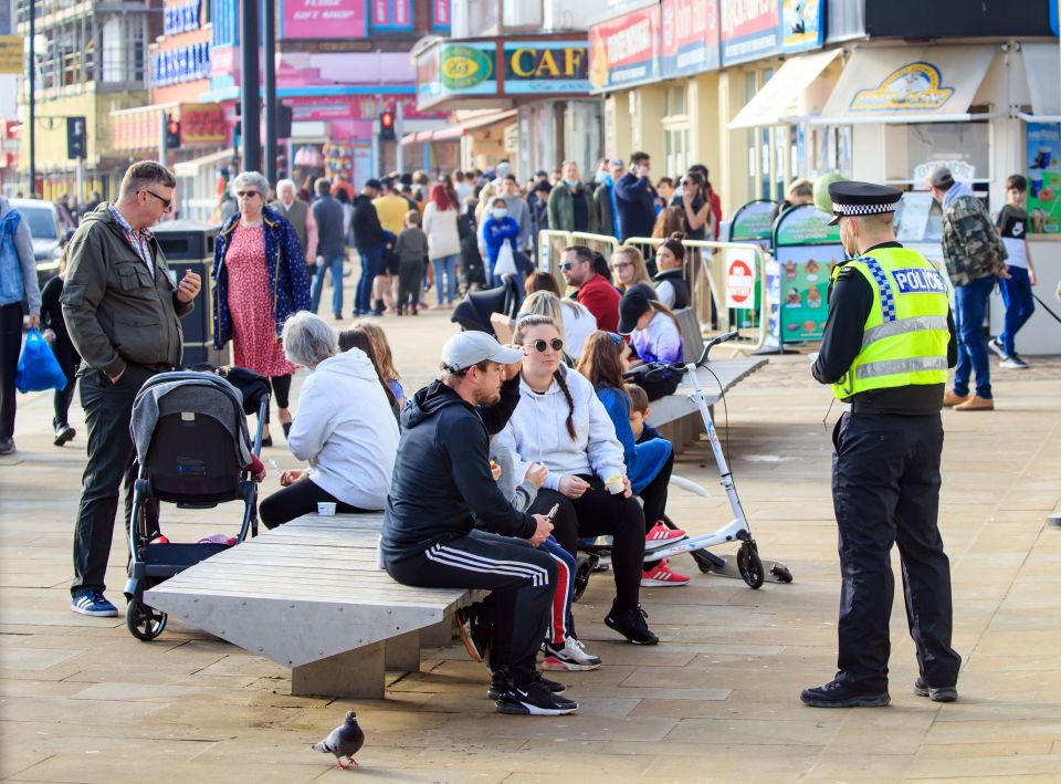 A police officer speaks to people in Scarborough, North Yorkshire