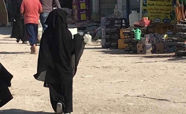 A little girl wears a burka in al-Hawl