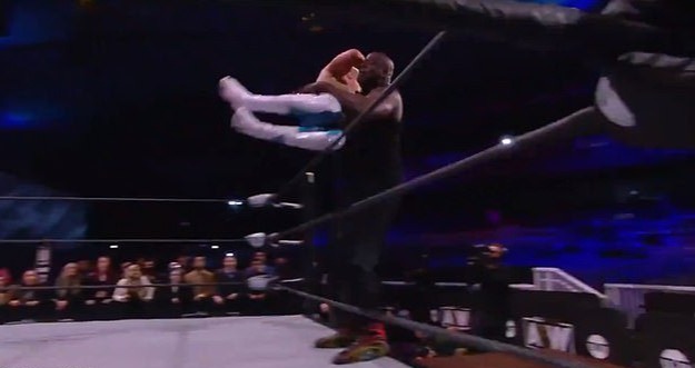 Cody Rhodes in a table bump with NBA icon Shaquille O'Neal